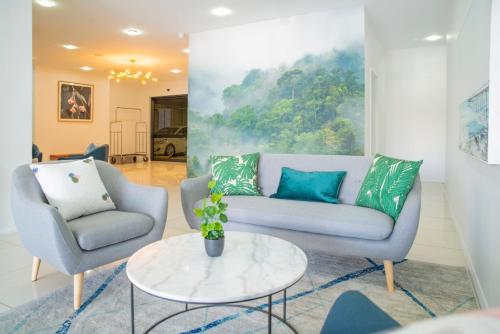 a living room with two chairs and a couch and a table at Mantra Wollongong in Wollongong