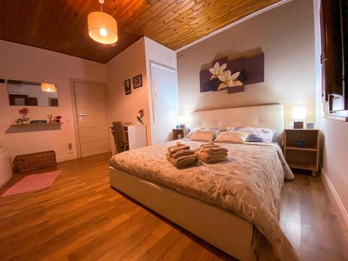 um quarto com uma cama grande com duas toalhas em FRIDA GUEST HOUSE em Iglesias