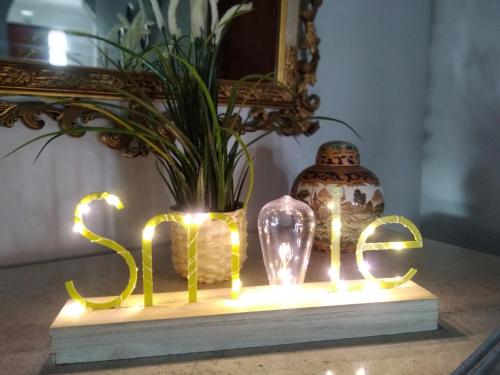 a table with lights and a vase with a plant at Vila Milreu Guest House in Estói