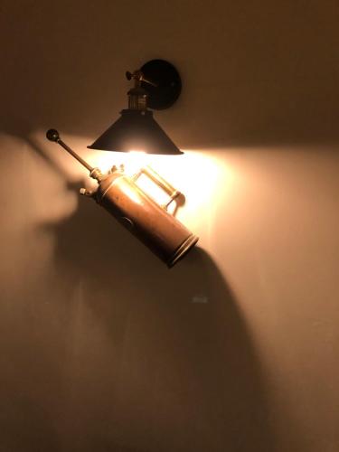 a lamp on a wall with a light on it at The Cornishman Inn in Tintagel