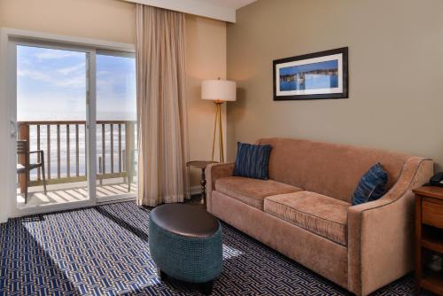 a living room with a couch and a balcony at Inn at Nye Beach in Newport
