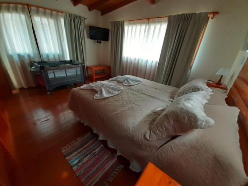 a bedroom with a large bed and a window at Cabañas Paseo de las Luces in Mar de las Pampas