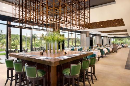 a large dining room with a long table and green chairs at Hyatt Regency Tokyo Bay in Tokyo