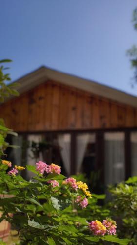 a wooden building with flowers in front of it at Z.Garden in Dali