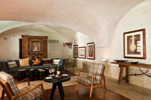 
a living room filled with furniture and a fireplace at Parador de Corias in Cangas del Narcea
