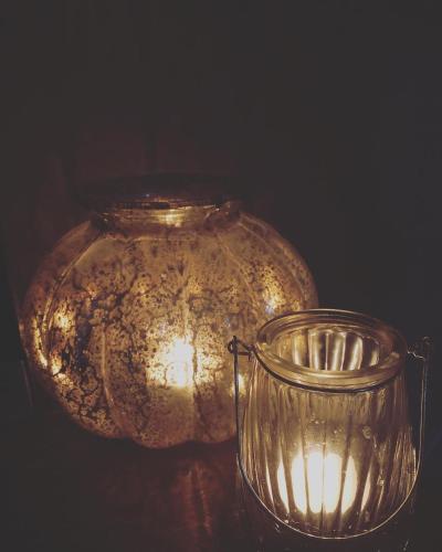 a glass jar and a candle holder on a table at Bed & Breakfast Yerseke in Yerseke