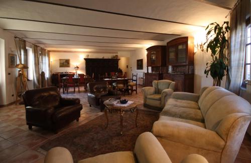 a living room with couches and chairs and a table at Relais San Desiderio in Calliano