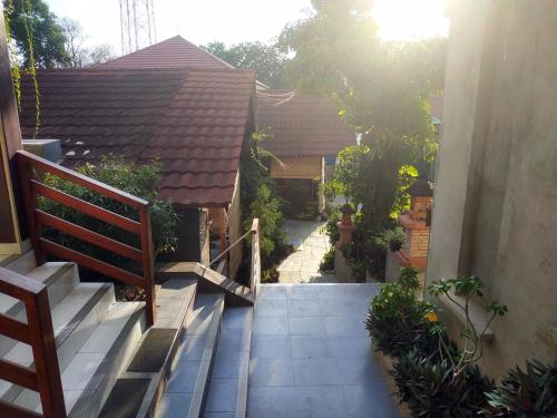 a stairway leading to a house with a bench at Komodo Lodge in Labuan Bajo