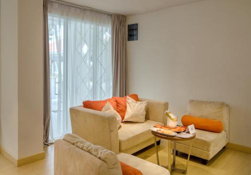 a living room with a couch and a chair at HARRIS Resort Barelang Batam in Sagulung