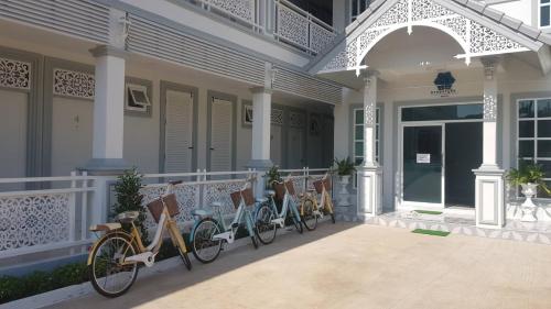 a row of bikes parked on the front of a house at Promporn Boutique Hotel in Nan