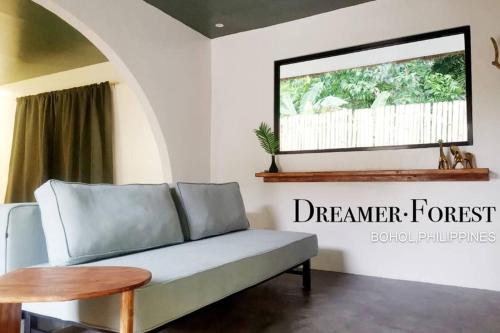 a living room with a couch and a window at Dreamer.Forest in Tangnan