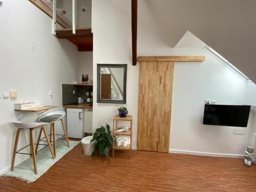 a living room with a tv and a table and chairs at Pension Skylark in Pardubice