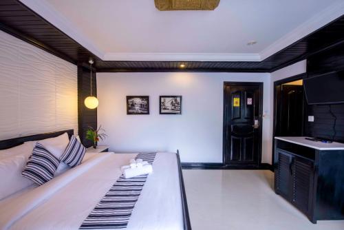 a living room with a couch and a tv at The Sanctuary Residence in Siem Reap