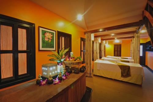a bedroom with two beds in a room with orange walls at The Sanctuary Residence in Siem Reap