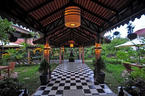 a pavilion with a checkered floor and a ceiling at The Sanctuary Residence in Siem Reap