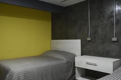 a bedroom with a bed and a dresser in it at TJ Border Suites by Hosted by Me in Tijuana