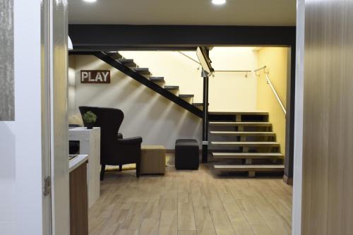 an office with a staircase with a chair and a desk at TJ Border Suites by Hosted by Me in Tijuana