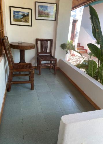 a living room with two chairs and a table at Marina Village in Moalboal