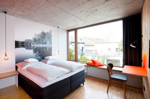 a bedroom with a bed and a large window at Hotel & Restaurant Zur Glocke in Höchstädt an der Donau