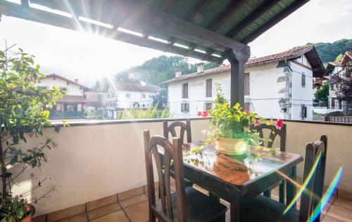 a table and chairs on a balcony with a view at Hotel SPA Atxaspi in Lesaka