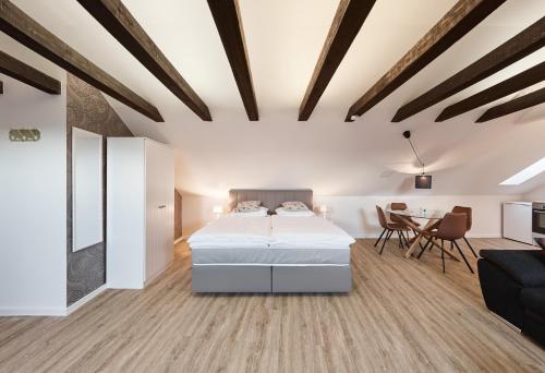 a bedroom with a bed and a dining room at Pension Wagener in Wachtendonk