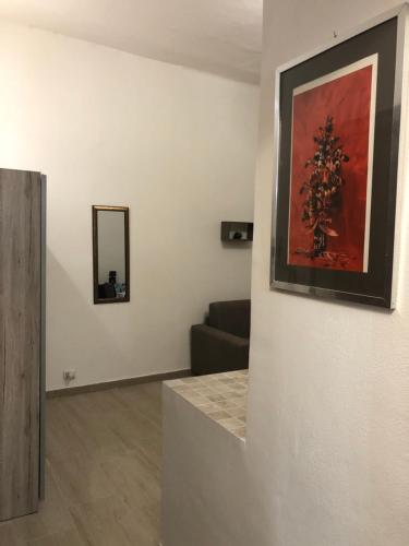 a living room with a couch and a painting on the wall at Civico 10 in Sassari