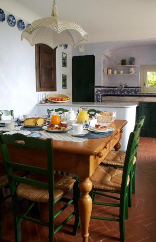 a kitchen with a wooden table with food on it at Agriturismo Natta Di Monte Tabor in Celle Ligure
