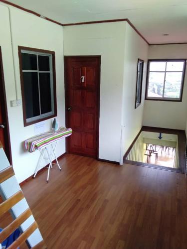 an empty room with a wooden floor and a door at Ren-Hana Kundasang in Kundasang