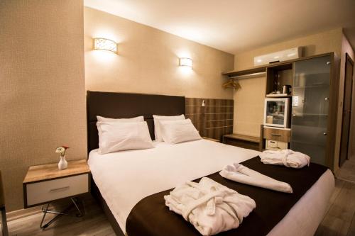 a hotel room with a bed with towels on it at Business Han Hotel in Nevsehir