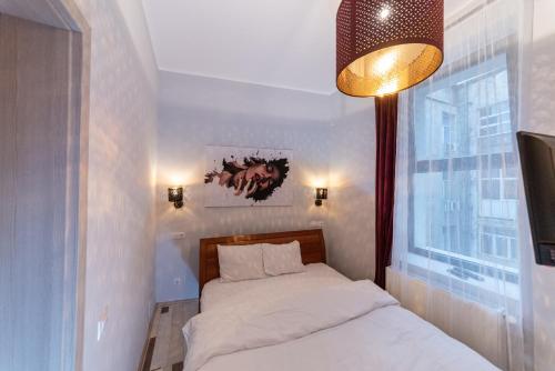 a small bedroom with two beds and a window at Heights Accommodation City Center in Bucharest