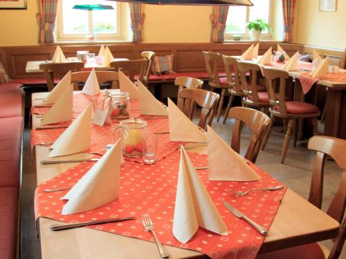 a table with paper napkins on a table in a restaurant at Brauerei_Gasthof Pfister in Eggolsheim