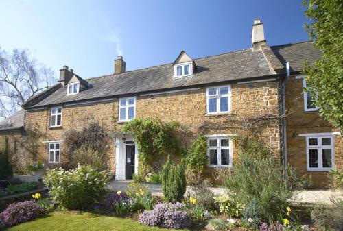an old brick house with a garden in front of it at Easington Guest House in Banbury