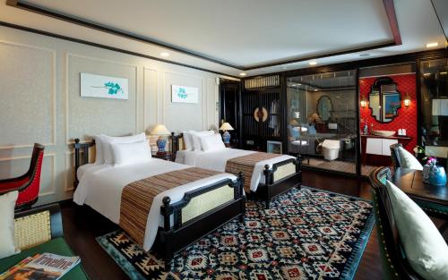 a hotel room with two beds and a bathroom at Orchid Premium Cruise in Ha Long