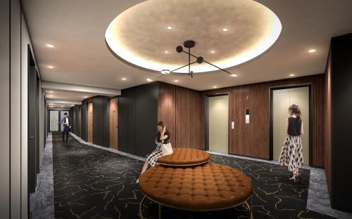 two women standing in a hallway with a table at Kobe Plaza Hotel West in Kobe