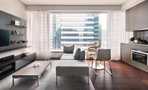 a living room with a couch and a table at EAST Residences in Hong Kong