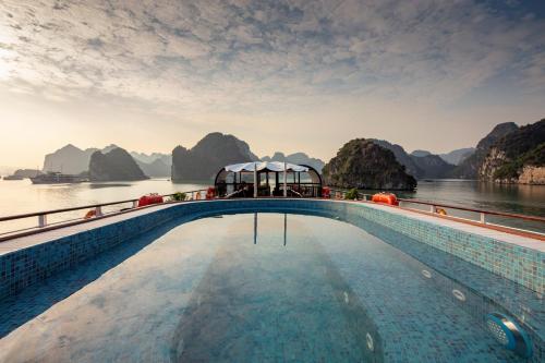 a cruise ship with a pool on the water at Orchid Premium Cruise in Ha Long