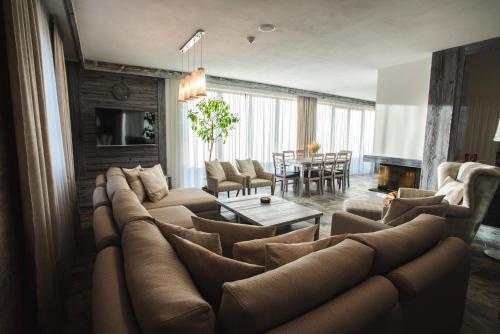 a living room with a large couch and a table at Vila Ambiente Donovaly in Donovaly