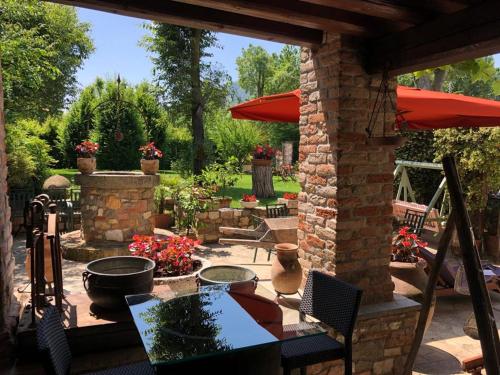 an outdoor patio with a table and an umbrella at Aiceltis in Teolo