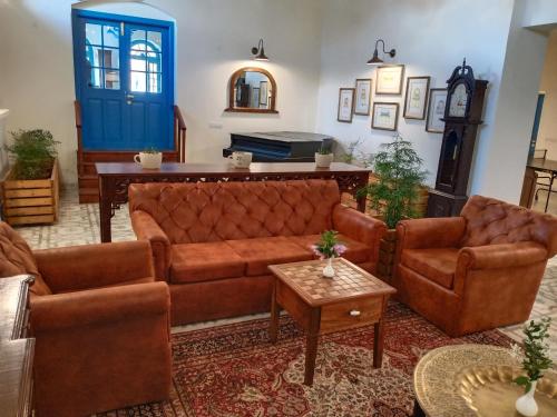 a living room with brown furniture and a blue door at Hotel Pine Retreat Mallroad in Mussoorie
