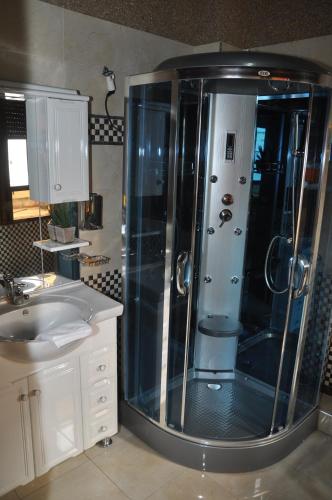 a bathroom with a shower and a sink at Riad Dar Mesouda in Tangier