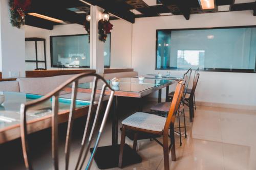 a dining room with a table and chairs at Amaris Bed & Breakfast in Mactan