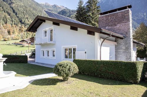 a white house with solar panels on it at Villa 10 in Oetz