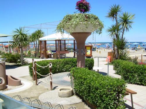 a large planter with flowers on top of a beach at Residence Veliero in San Mauro a Mare
