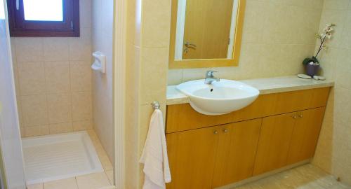 a bathroom with a sink and a mirror at 3 bedroom Villa Cardia with private pool, Aphrodite Hills Resort in Kouklia