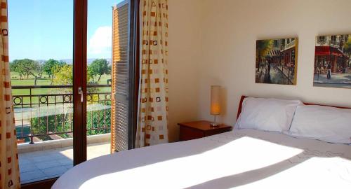 a bedroom with a bed and a large window at 3 bedroom Villa Cardia with private pool, Aphrodite Hills Resort in Kouklia
