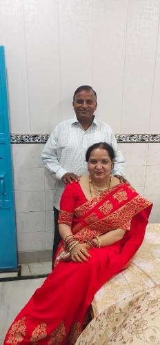 a man standing next to a woman in a red dress at Sunita homestay in Agra