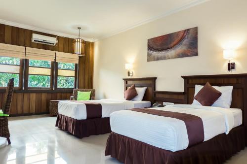 מיטה או מיטות בחדר ב-Arsela Hotel Pangkalan Bun
