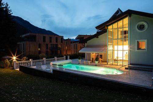 a house with a swimming pool next to a building at Villa 10 in Oetz