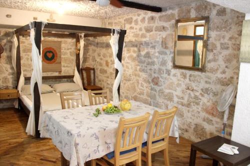 a dining room with a table and a bedroom at Charming Studio in Betina, 30 m², Terrace in Betina