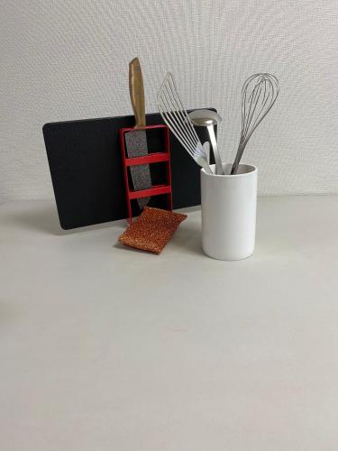 a white container with utensils on a counter at ⑳都宿 松 in Osaka